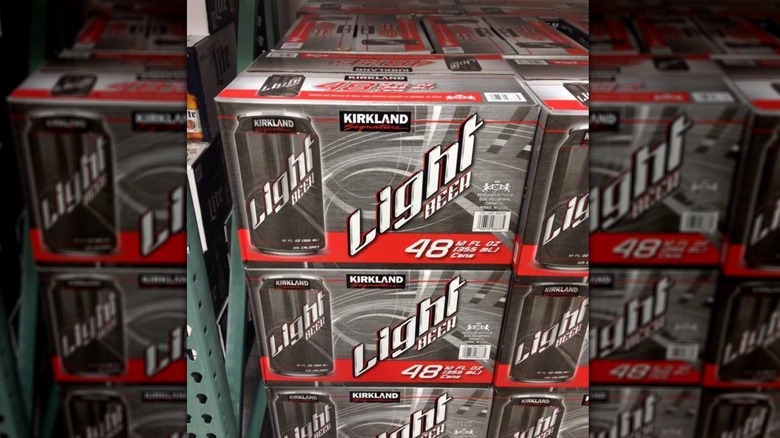 Stacked grey-andwhite cases of Kirkland Signature light beer