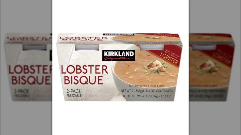 Package of Kirkland Signature lobster bisque featuring a chunk of lobster meat in creamy soup