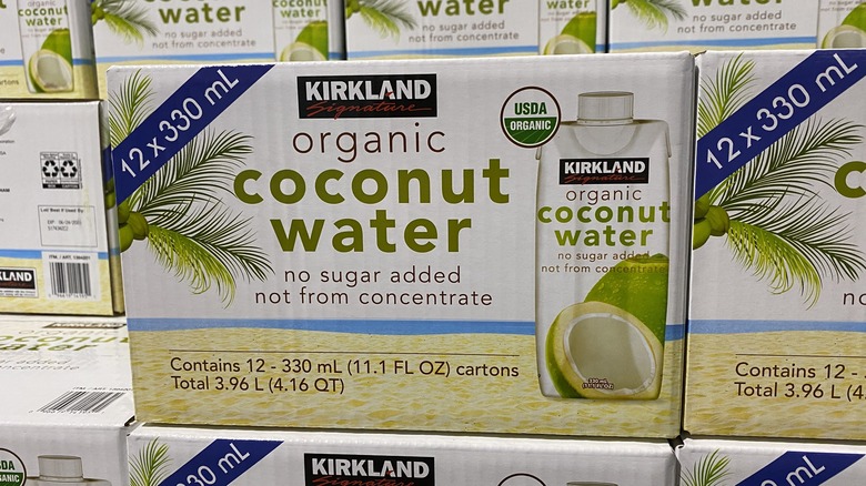 Box of Kirkland organic coconut water in stack of similar boxes
