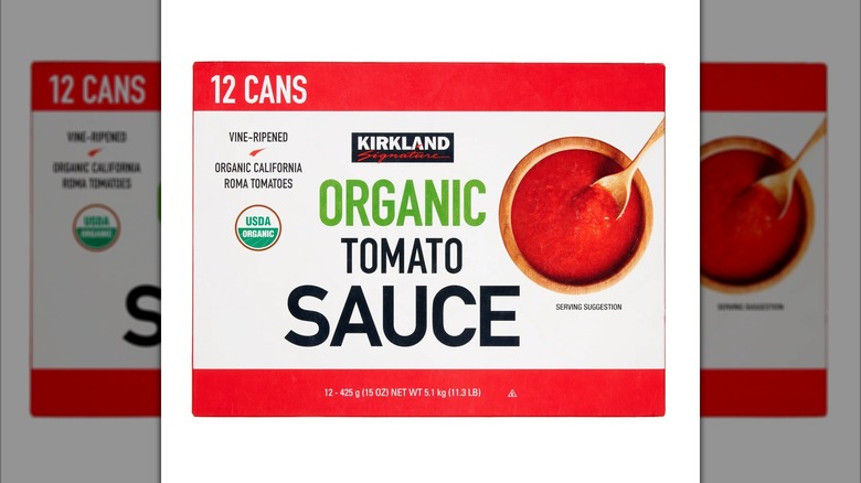 Advertisement for box of Kirkland Signature organic tomato sauce on white background