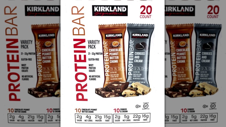Advertisement for Kirkland Signature protein bars, two-pack of chocolate peanut butter and cookies and cream flavors