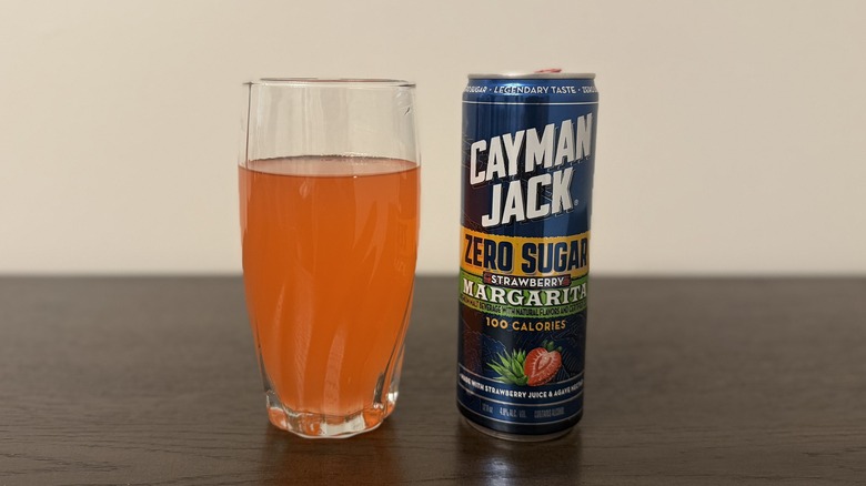 Strawberry Cayman Jack Zero Sugar Margarita in a glass and a can.