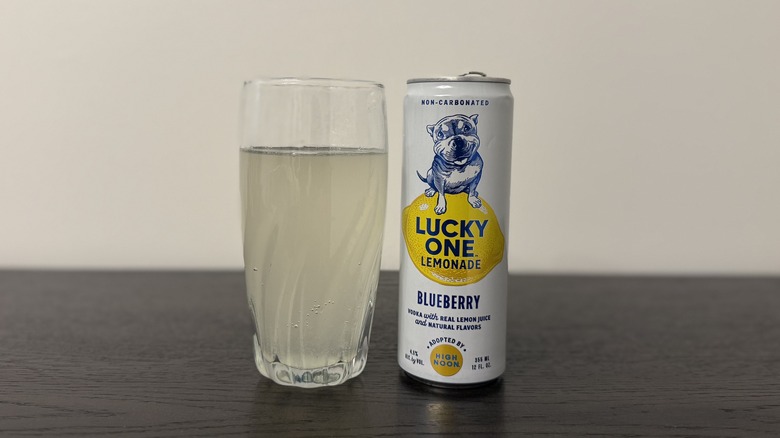 Blueberry Lucky One Vodka Lemonade in a glass and a can.