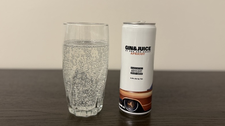 Apricot Gin & Juice by Dre and Snoop in a glass and a can.