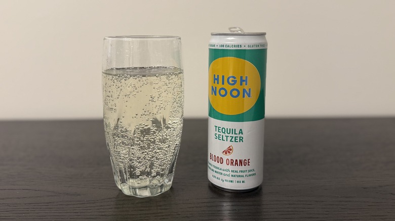 Blood Orange High Noon Tequila Seltzer in a glass and a can.