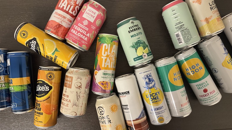 Various low-sugar canned cocktails laid out on table.