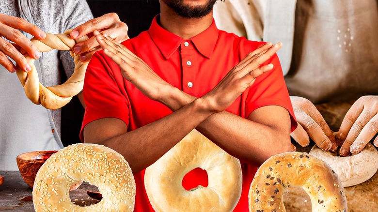 Man with crossed arms behind bagels
