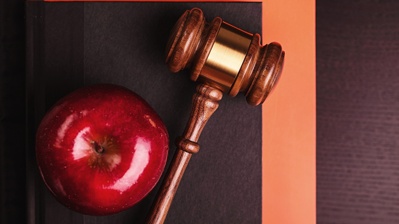 Apple and gavel on desk