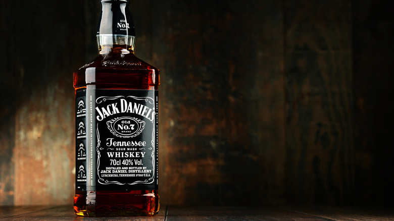 Bottle of Jack Daniel's on dark wood background