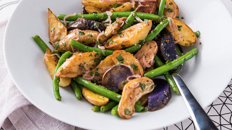 Bowl of cooked potato salad with green beans