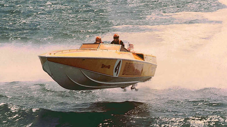 Hiroaki Aoki mid-air in a speed boat with Benihana writing on the side