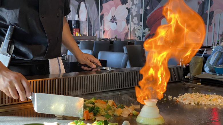 Teppanyaki chef with flaming food