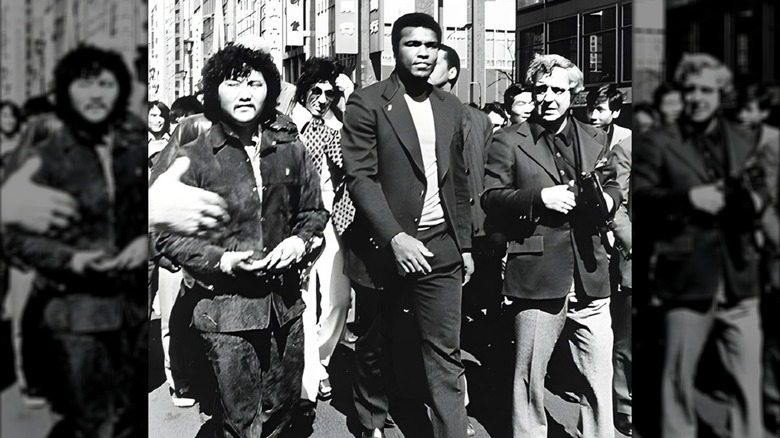 Hiroaki Aoki seen walking the street next to his friend Muhammad Ali