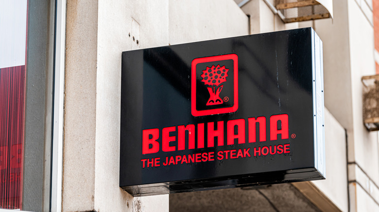A close-up of a Benihana signage with its logo and tagline