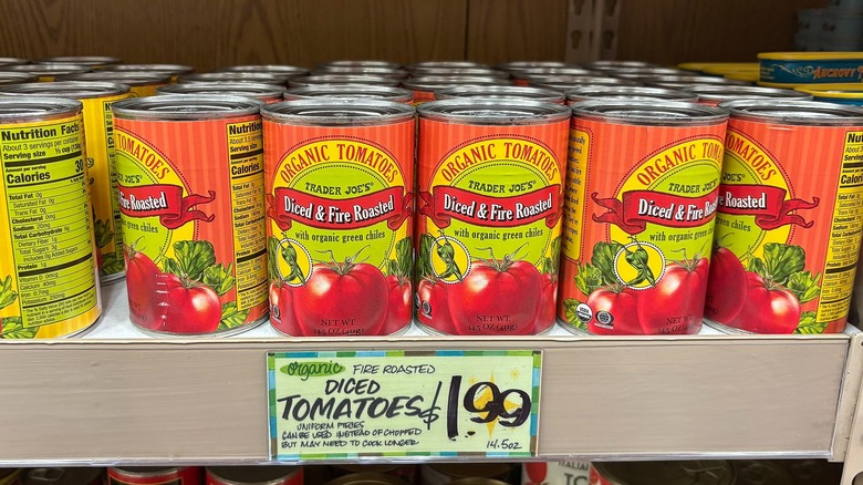 Cans of organic diced fire-roasted tomatoes on shelf at Trader Joe's