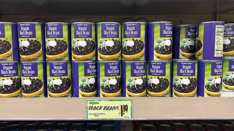 Cans of organic black beans on shelf at Trader Joe's