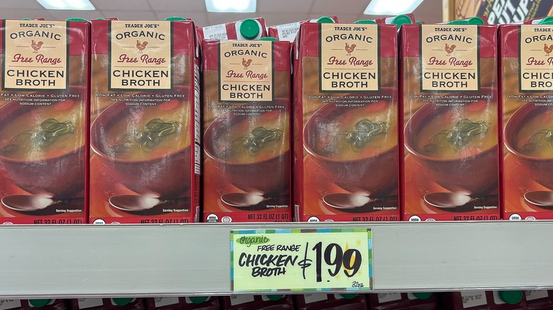 Boxes of Trader Joe's organic chicken broth on shelf in store