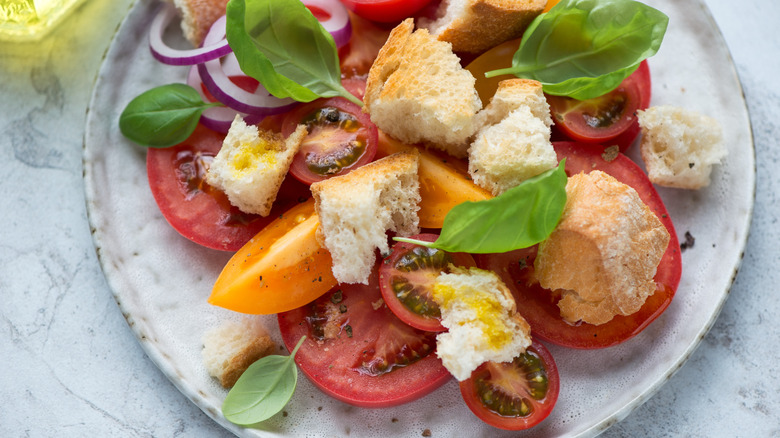 plate with Panzanella salad on white table