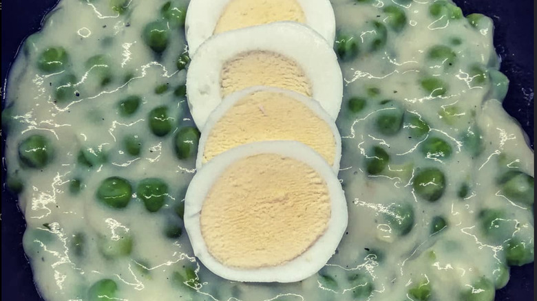 Creamed peas with sliced hard boiled eggs