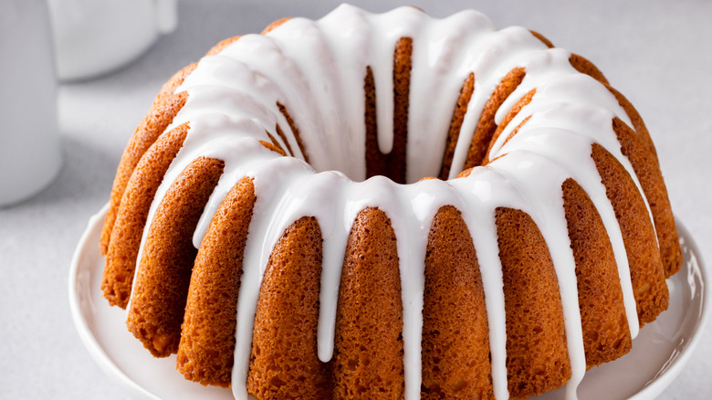 A bundt cake with white frosting