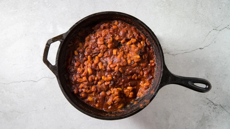 cast iron pan with spicy baked beans
