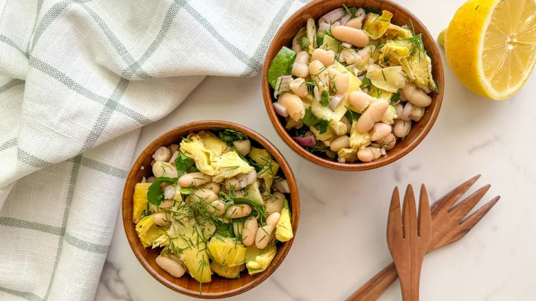 two bowls of white bean and roasted artichoke salad