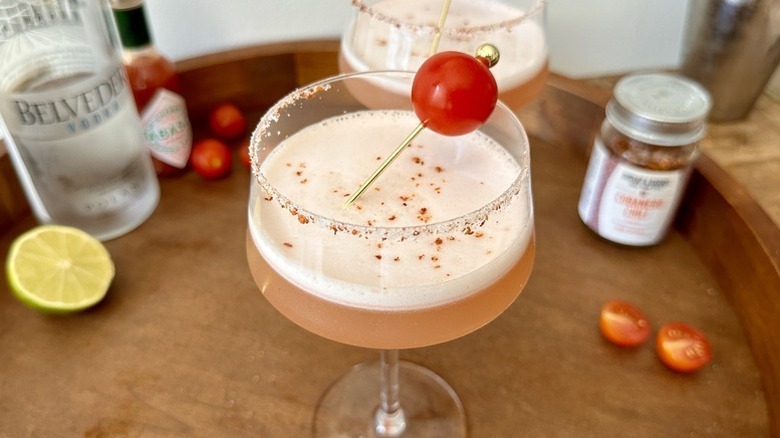 Spicy tomato martini in coupe glass with cherry tomato garnish