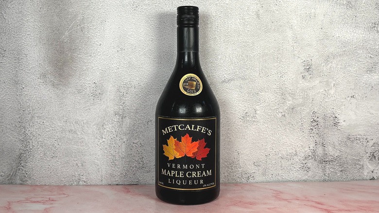 Bottle of Metcalfe's Vermont Maple Cream Liqueur on grey wall background