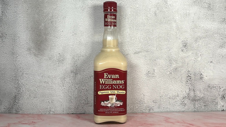 Bottle of Evan Williams Peppermint White Chocolate Egg Nog on grey wall background