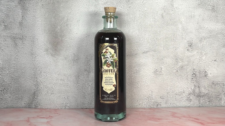 Bottle of Veritable Coffee Liqueur on grey wall background