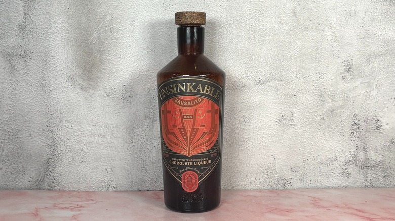 Bottle of Sausalito Unsinkable Chocolate Liqueur on grey wall background