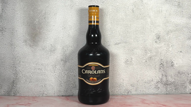 Bottle of Carolans Salted Caramel on grey wall background