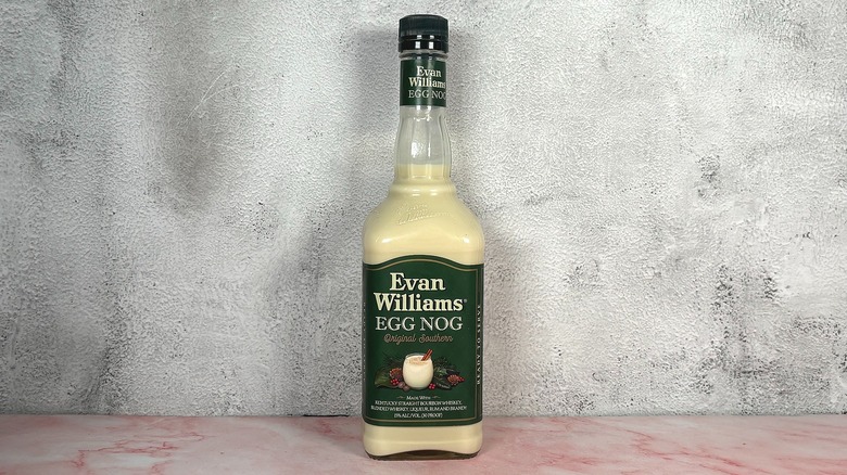 Bottle of Evan Williams Egg Nog on grey wall background
