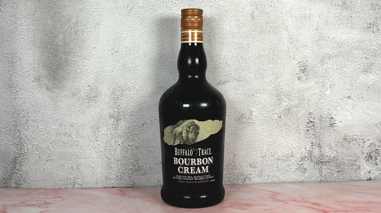 Bottle of Buffalo Trace Bourbon Cream on grey wall background