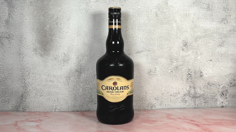 Bottle of Carolans Irish Cream Liqueur on grey wall background