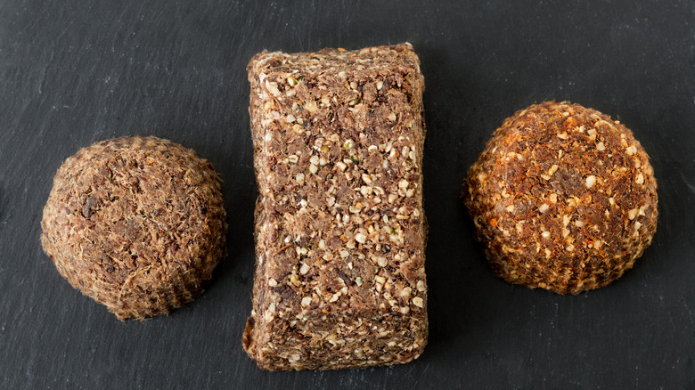 Three different types of pemmican on a dark grey background