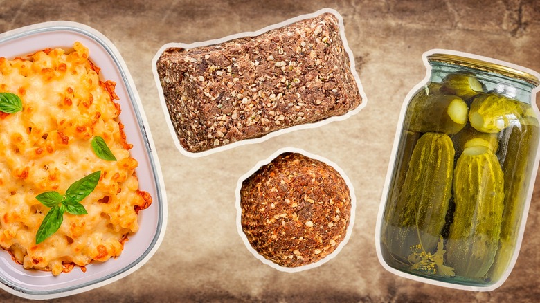 Pickles, pemmican, and macaroni and cheese on a rustic stone background