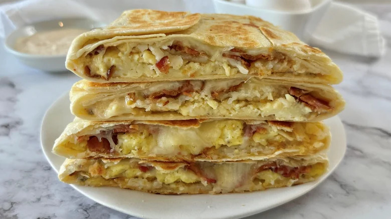 Copycat Taco Bell Breakfast Crunchwrap sliced and stacked on a plate