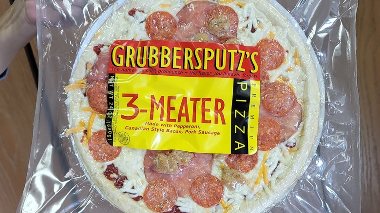 image of a Grubbersputz's brand frozen "3-Meater" pizza in its packaging