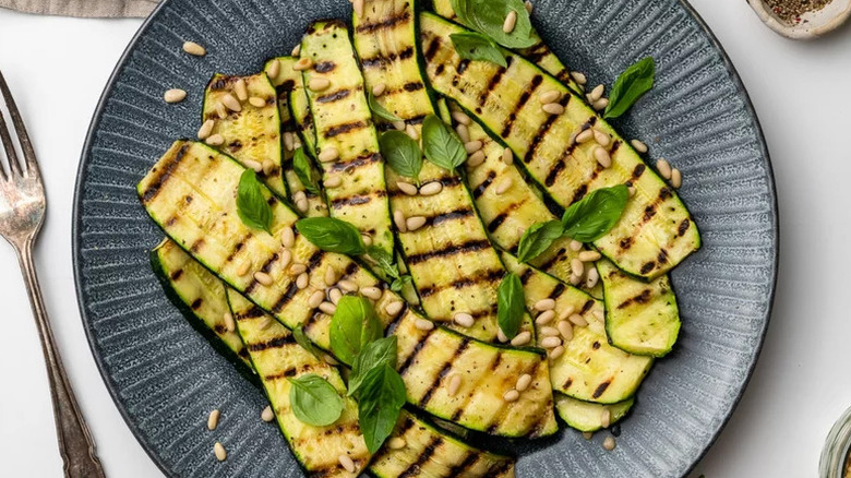 Garlicky Grilled Zucchini on textured grey plate