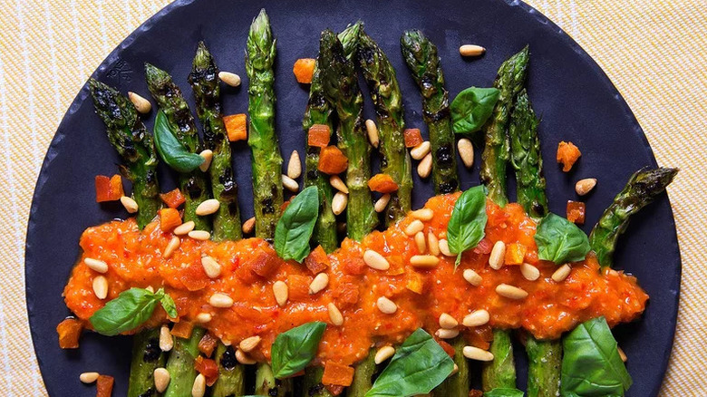 Grilled Asparagus with Apricot and Pine Nut Romesco on blue plate