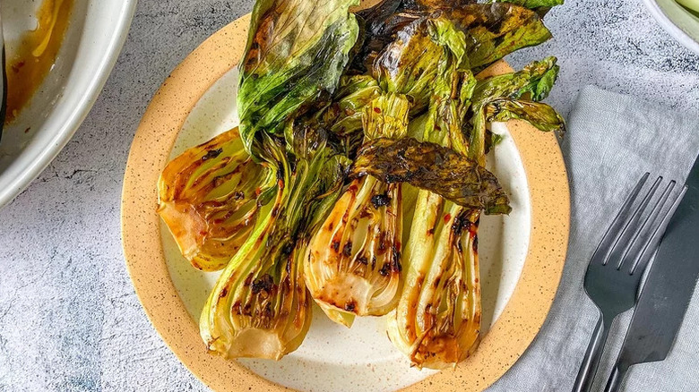 Grilled Bok Choy on yellow and white plate