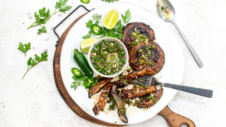 Grilled Portobello Mushrooms with Jalapeño Chimichurri on white plate with fork