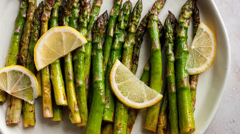 Lemony Grilled Asparagus with lime slices on white plate