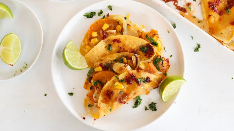 Roasted Corn and Squash Quesadillas with Hot Honey Dipping Sauce on white plate with limes