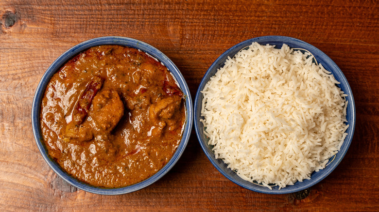 Bowl of Chettinad chicken alongside bowl of rice