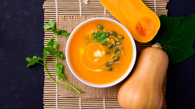 Bowl of butternut squash soup with pumpkin seed garnish