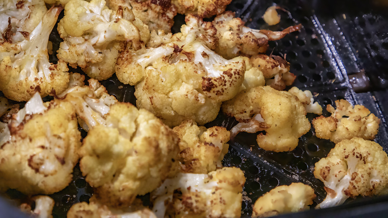 Roasted cauliflower in air fryer basket