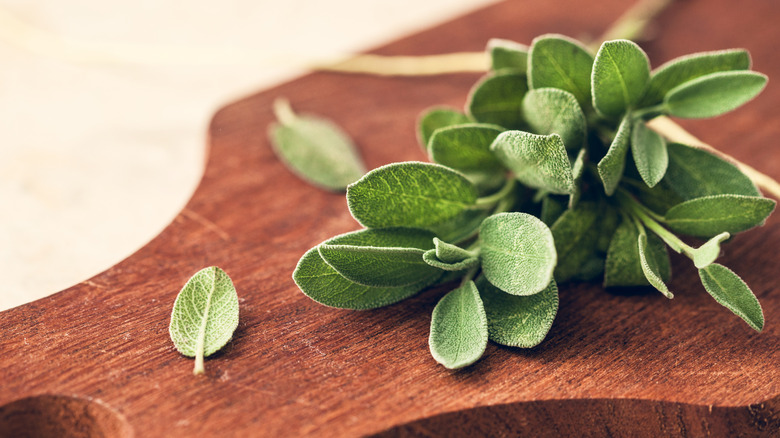 Sage leaves on wooden cutting board