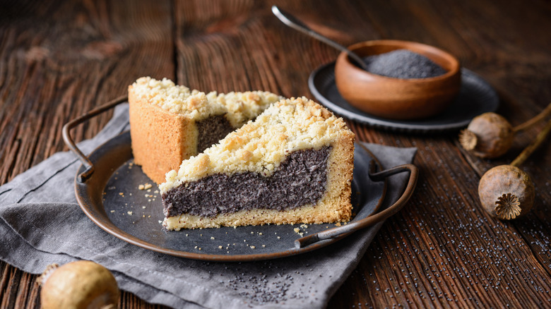 Mohnkuchen on serving tray with bowl of poppy seeds in background